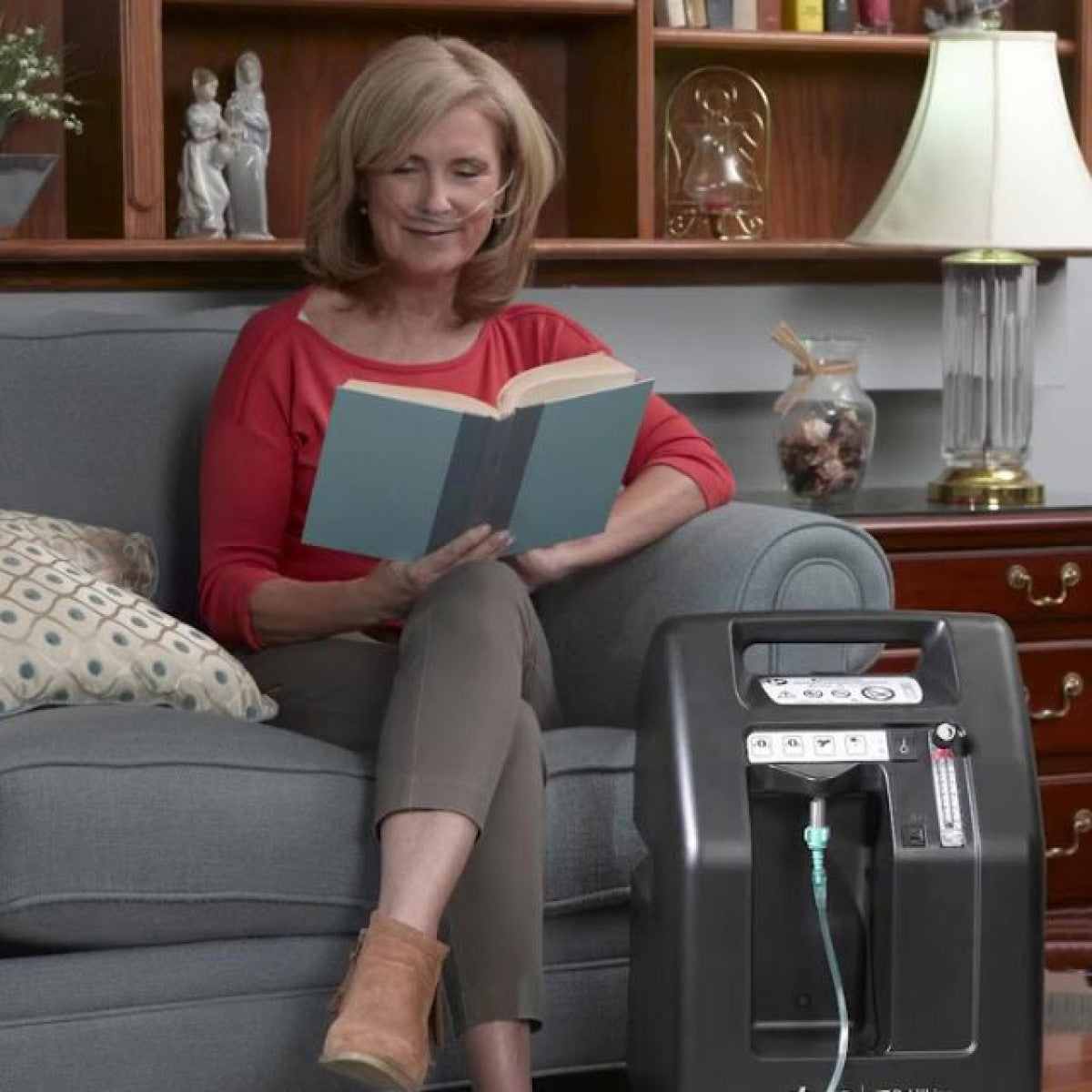 Woman Sitting On Couch Using DeVilbiss Healthcare's Drive 5 Liter Oxygen Concentrator