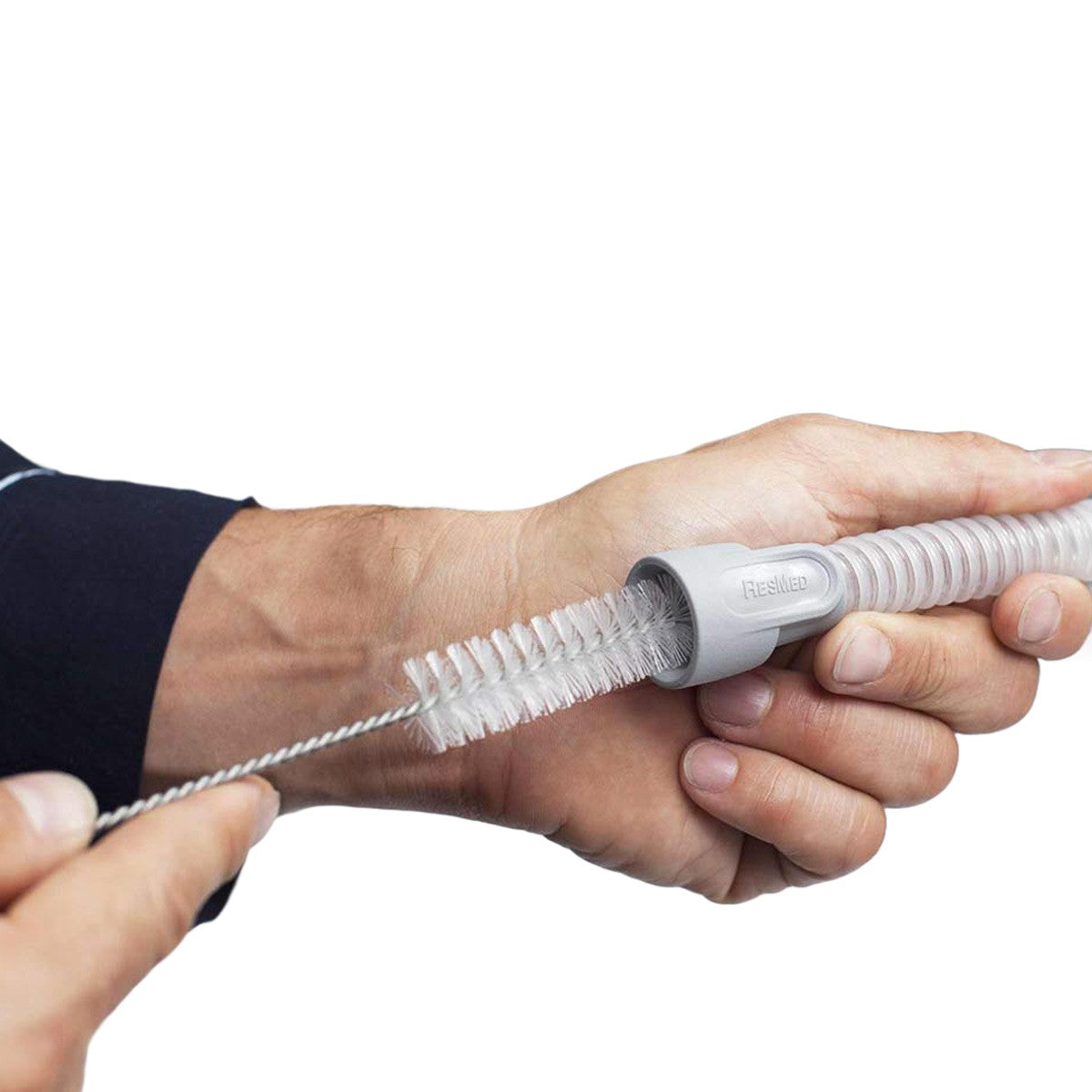Stock Image of Person Cleaning Their CPAP Hose Tubing W/ CPAP Tubing Brush