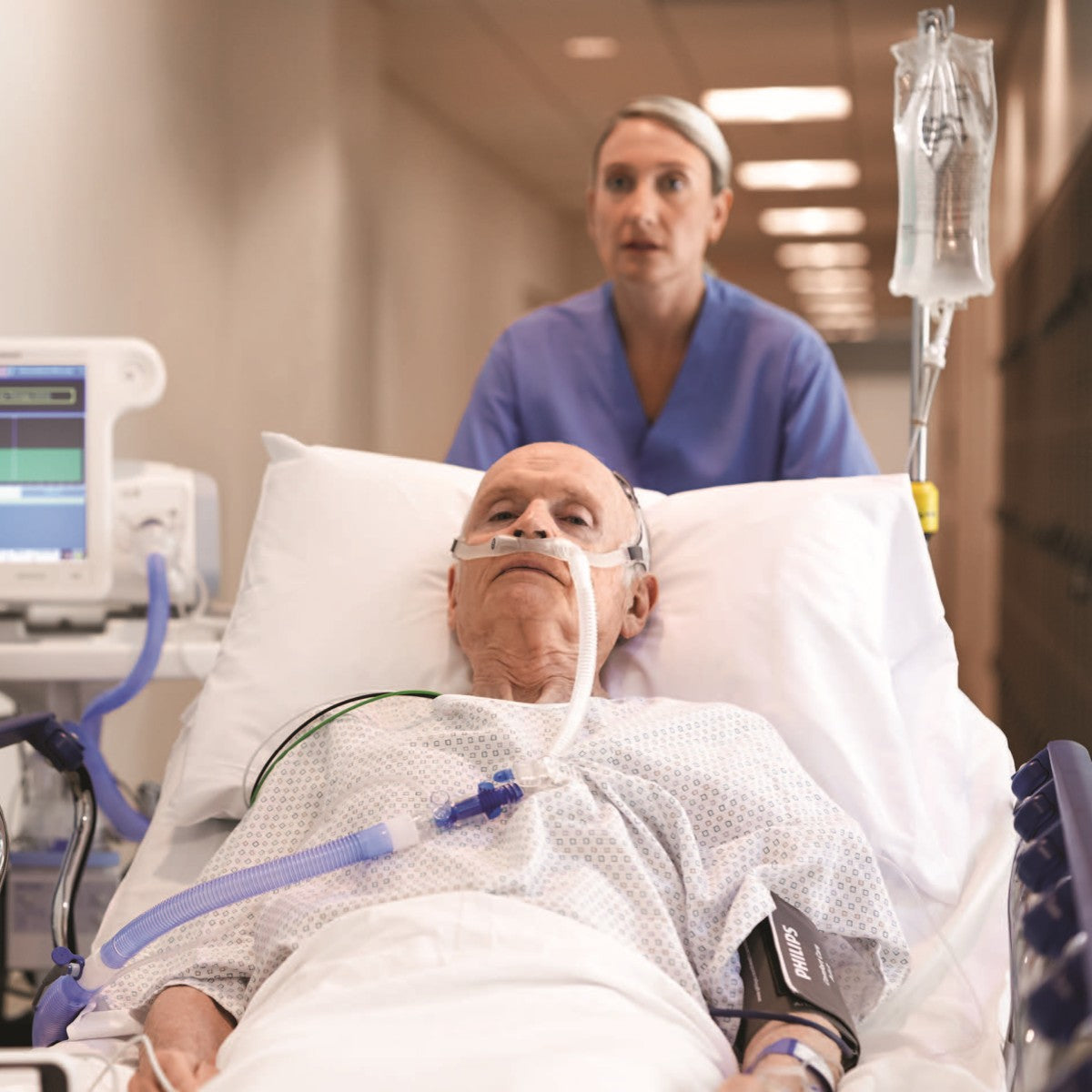 Nurse Taking Patient Wearing Philips Respironics AC611 High Flow Nasal Cannula