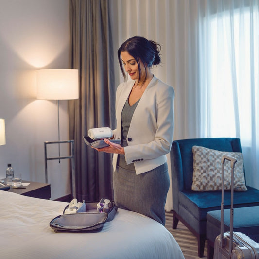 Photo of woman holding ResMed AirMini Travel CPAP Machine and Machine Case