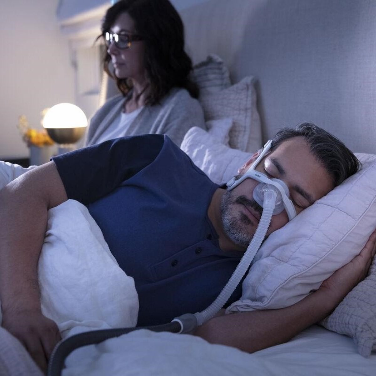 Photo of man using ResMed AirTouch N20 nasal CPAP mask with headgear