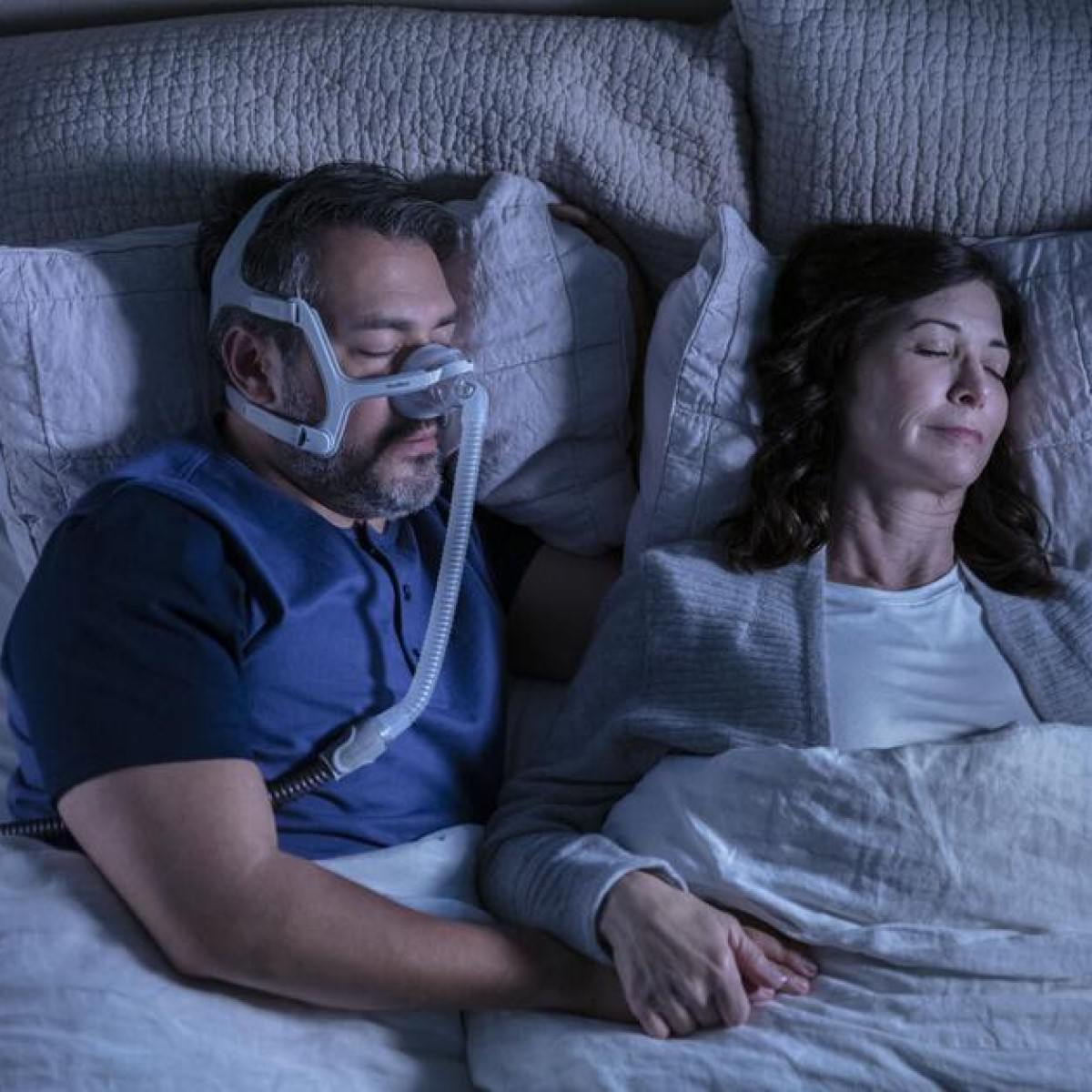Photo of man using ResMed AirTouch N20 nasal CPAP mask with headgear