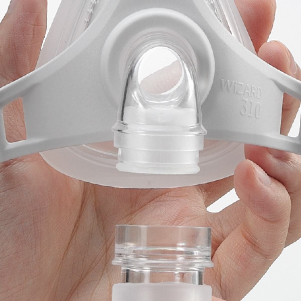 Stock photo of hand holding Apex Medical Wizard 310 nasal CPAP mask without headgear