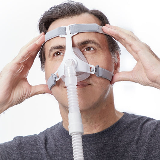 Stock photo of man wearing Apex Medical Wizard 310 nasal CPAP mask with headgear