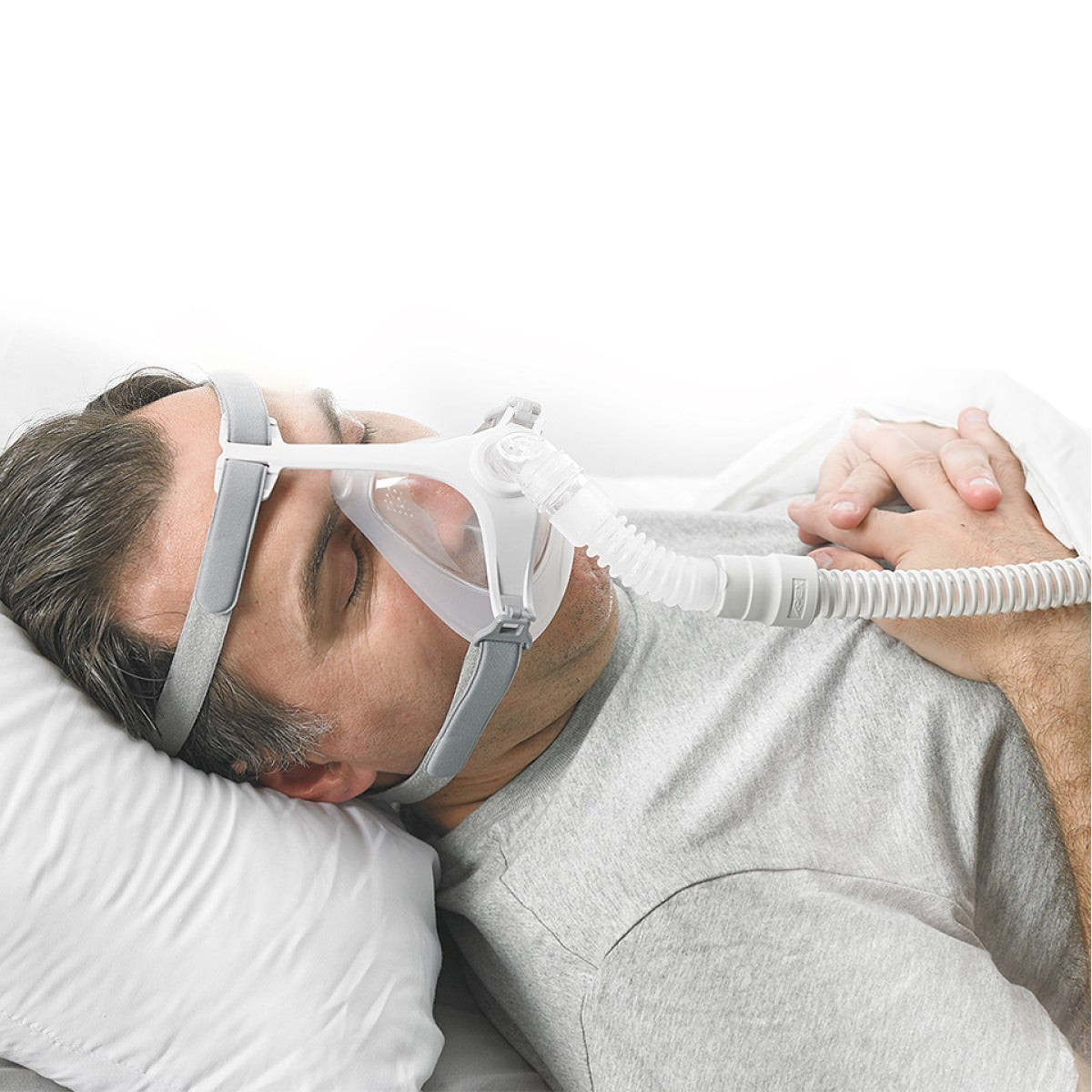 Stock photo of man using Apex Medical Wizard 320 full face CPAP mask with headgear