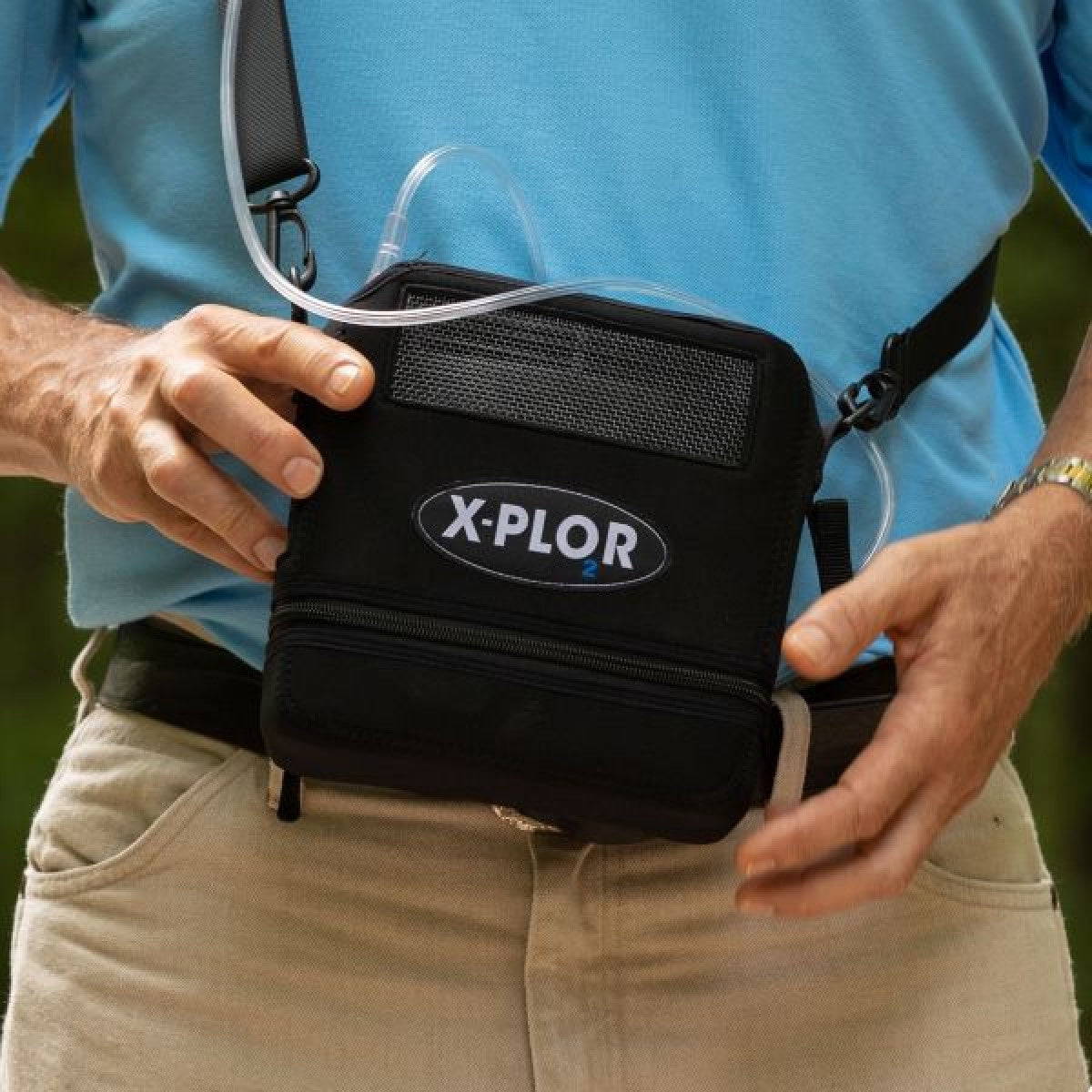 Man Holding Bellascura Portable Oxygen Concentrator Outside
