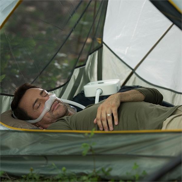 Man Sleeping in Tent Using His Philips Respironics DreamStation Go Auto Travel CPAP Machine