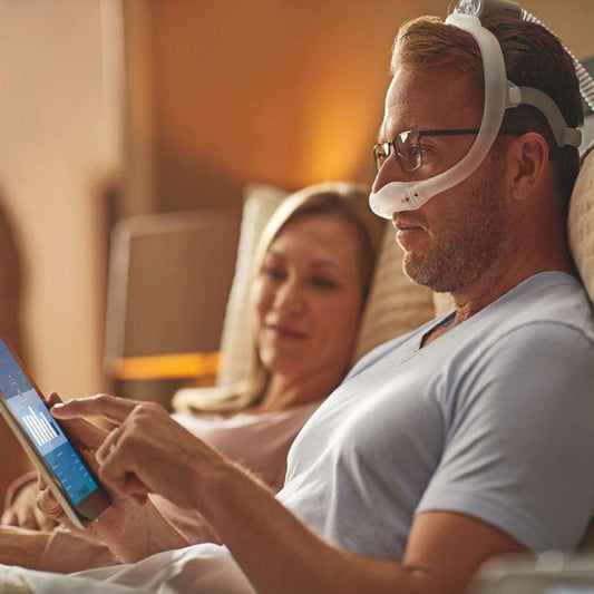 Man Checking on His Sleep Report W/ His Partner
