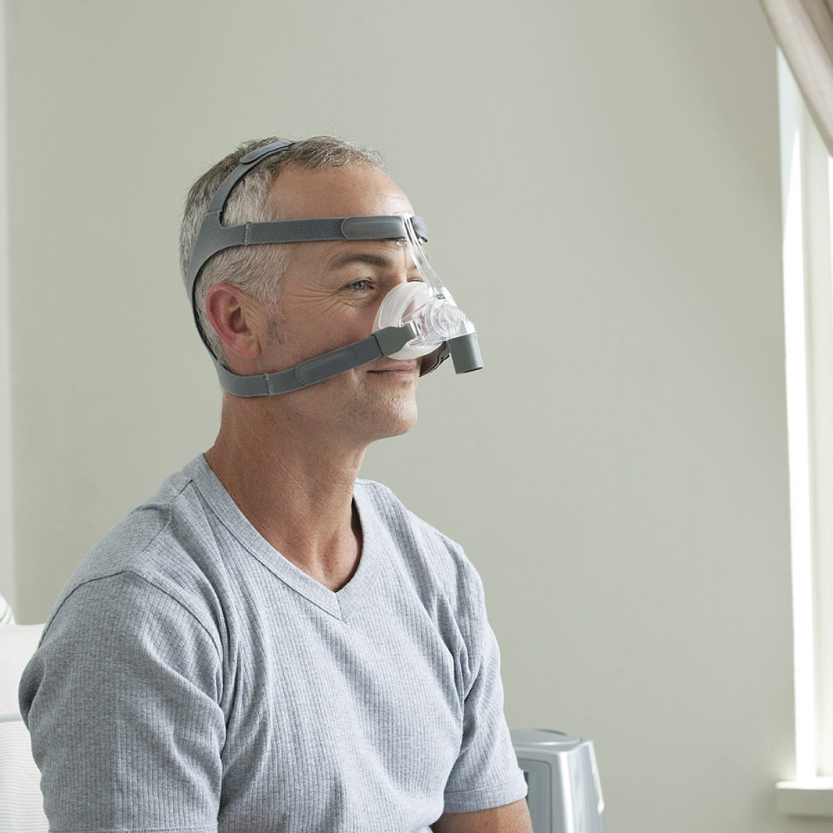 Photo of man wearing Fisher & Paykel Eson nasal CPAP mask with headgear