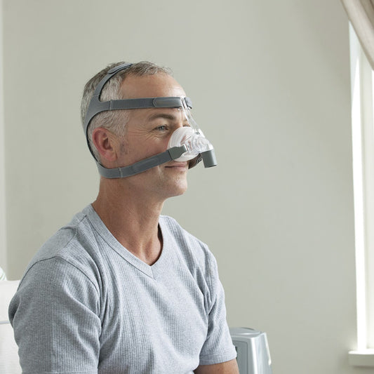 Photo of man wearing Fisher & Paykel Eson nasal CPAP mask with headgear