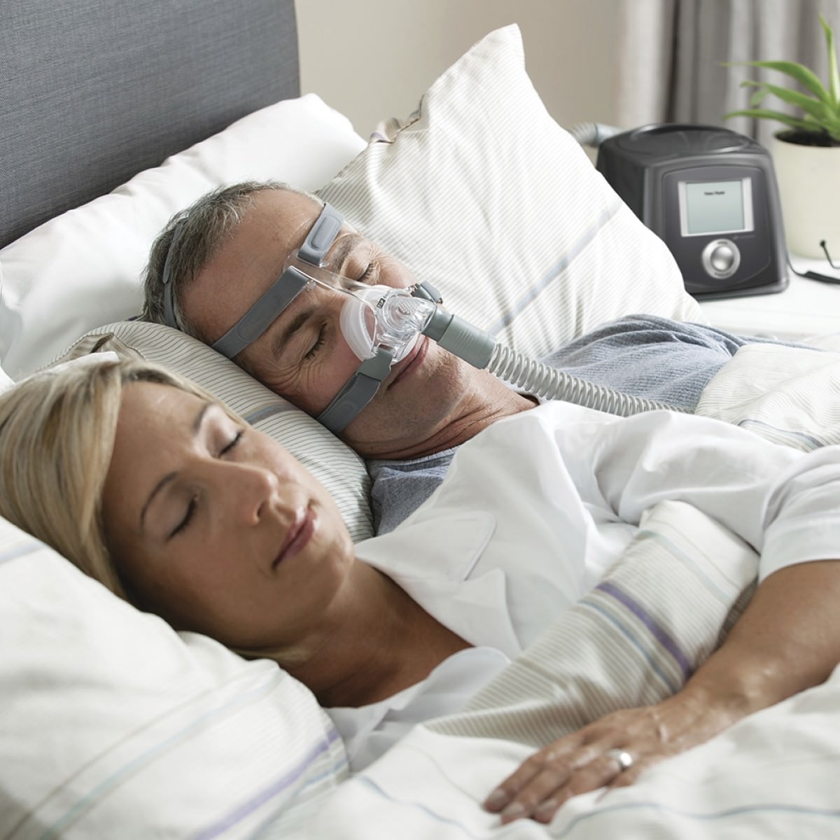 Photo of man using Fisher & Paykel Eson nasal CPAP mask with headgear