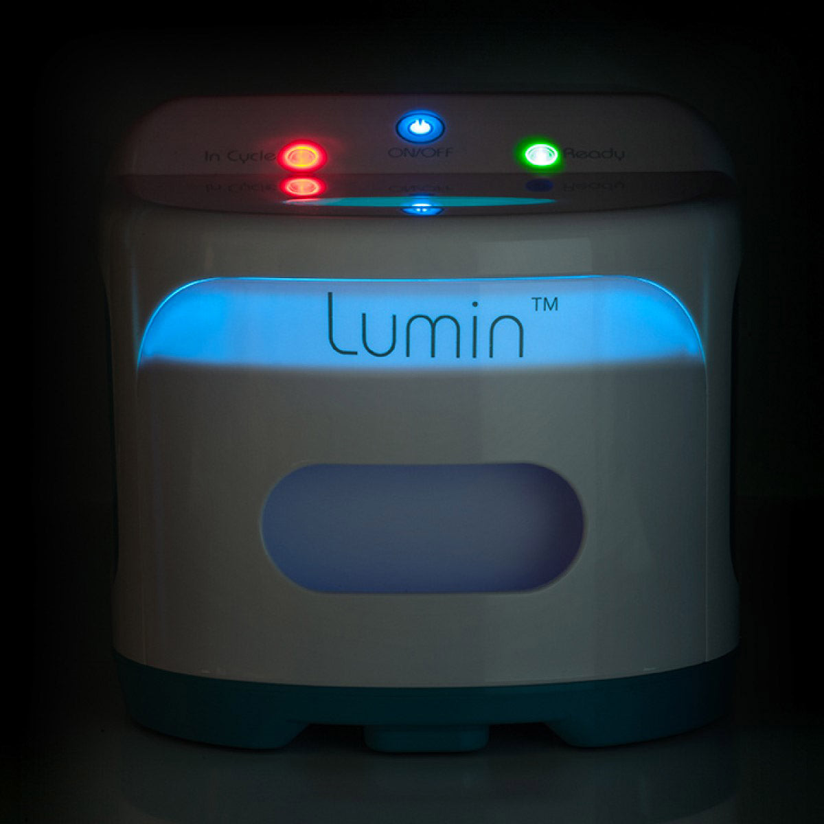 Stock photo of React Health Lumin CPAP Mask and Accessory Cleaner in a dark room powered on