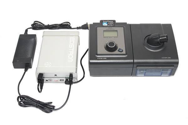 Stock photo of Choice One Medical Medistrom Co Pilot 12 CPAP machine battery add on unit plugged into CPAP machine