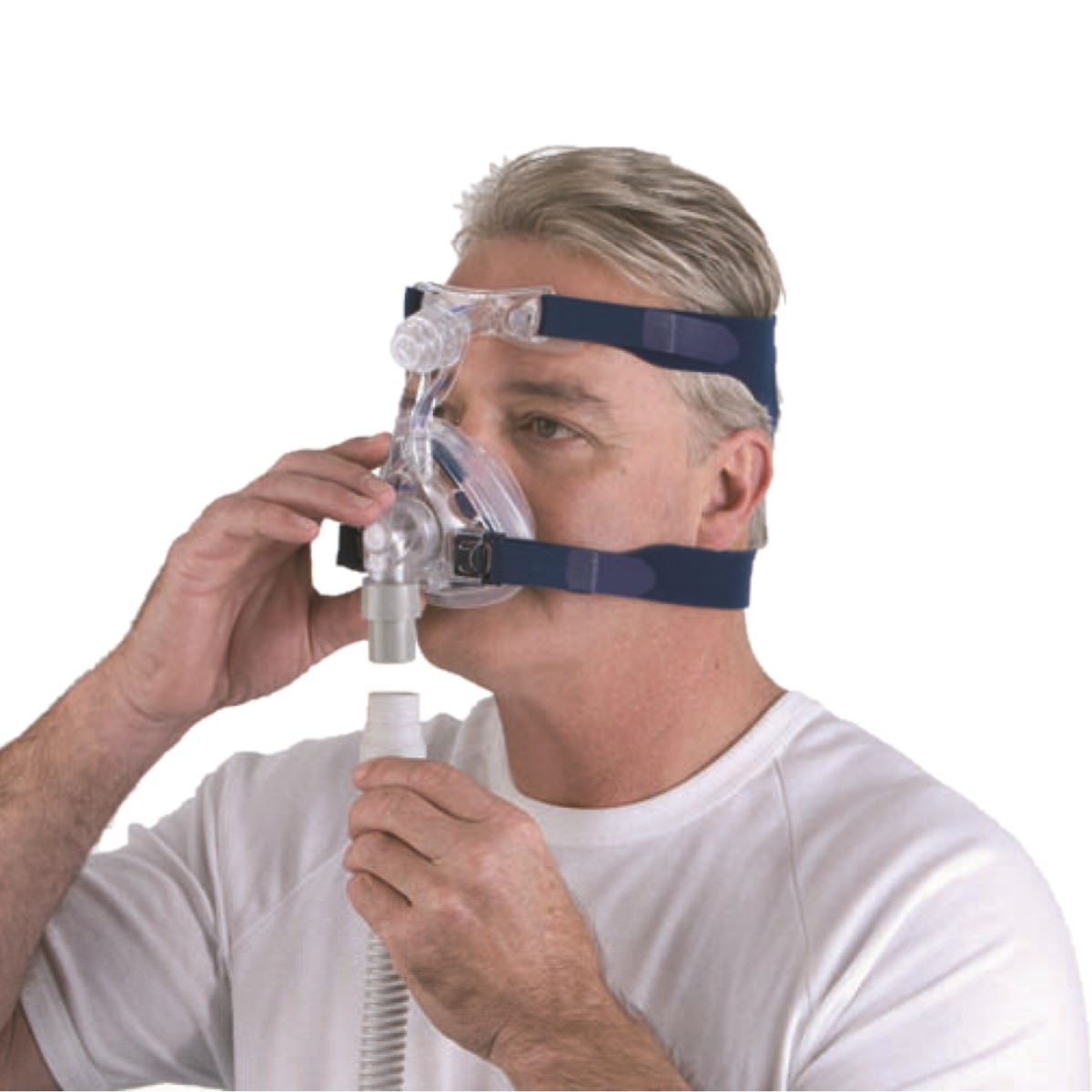 Left angled man wearing ResMed Mirage Activa LT CPAP mask and connecting tubing to it