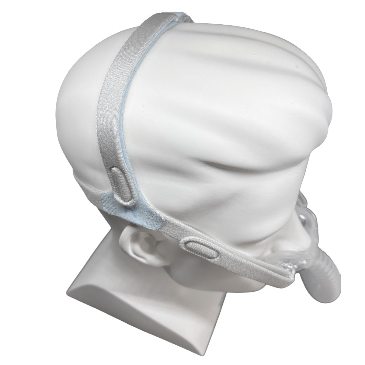 A white mannequin head and neck stand displaying a sleep apnea or CPAP-style mask with a light gray elastic headband on a plain white background.