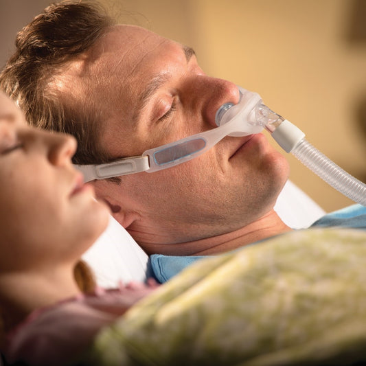 Photo of man using Philips Respironics Nuance Pro nasal pillow CPAP mask frame