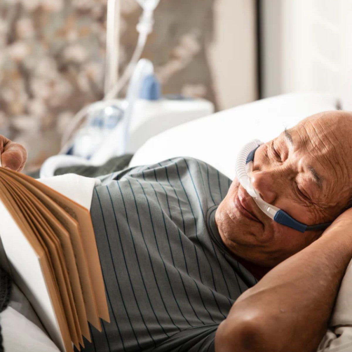 Photo of man sleeping while wearing Fisher & Paykel OptiFlow nasal cannula size medium
