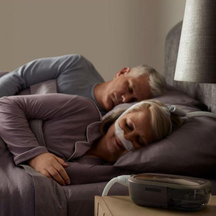 Photo of woman using Philips Respironics Certified Refurbished DreamStation 2 Auto CPAP machine