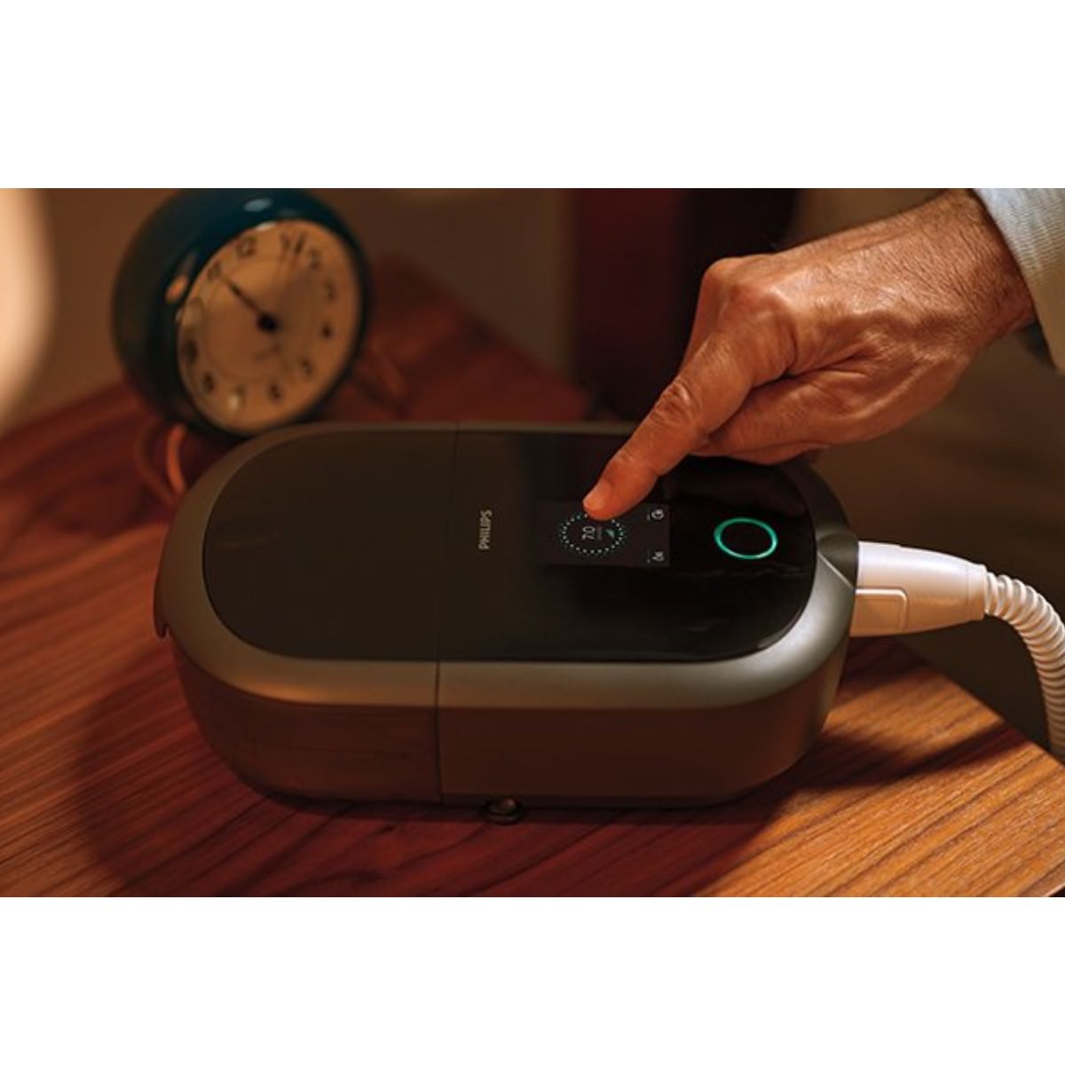 Photo of man turning on Philips Respironics DreamStation 2 Auto CPAP machine