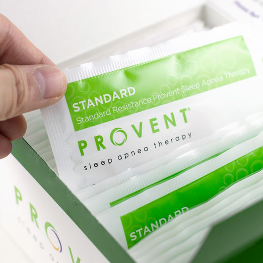 Stock photo of a hand holding Provent Sleep Therapy 30 day starter pack