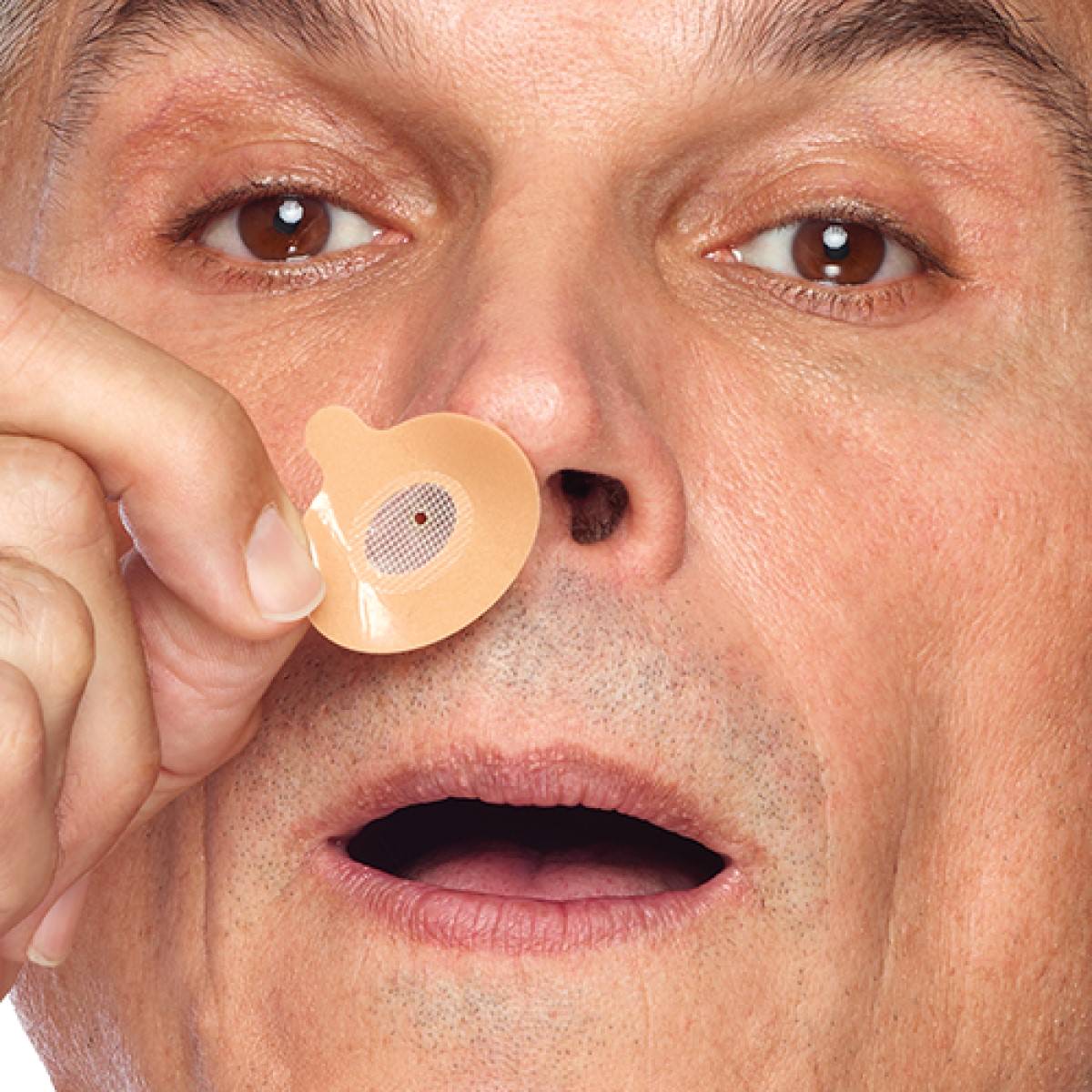 Photo of man putting Provent Sleep Therapy 30 day starter kit on his nose