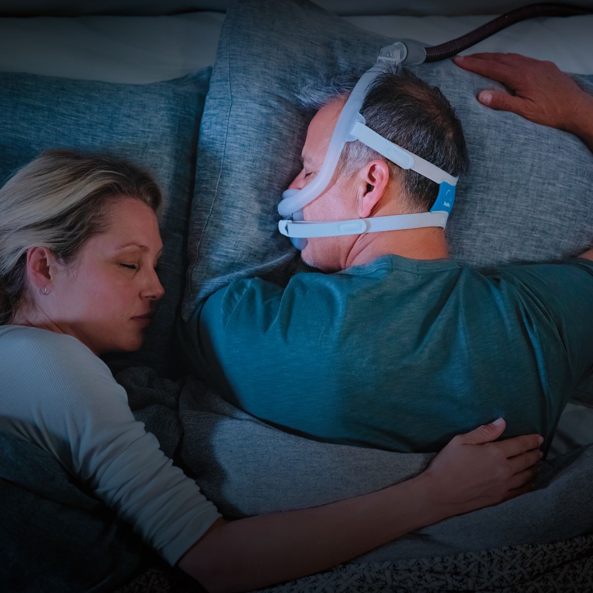 Man sleeping while wearing ResMed AirFit F30i full face CPAP mask with headgear