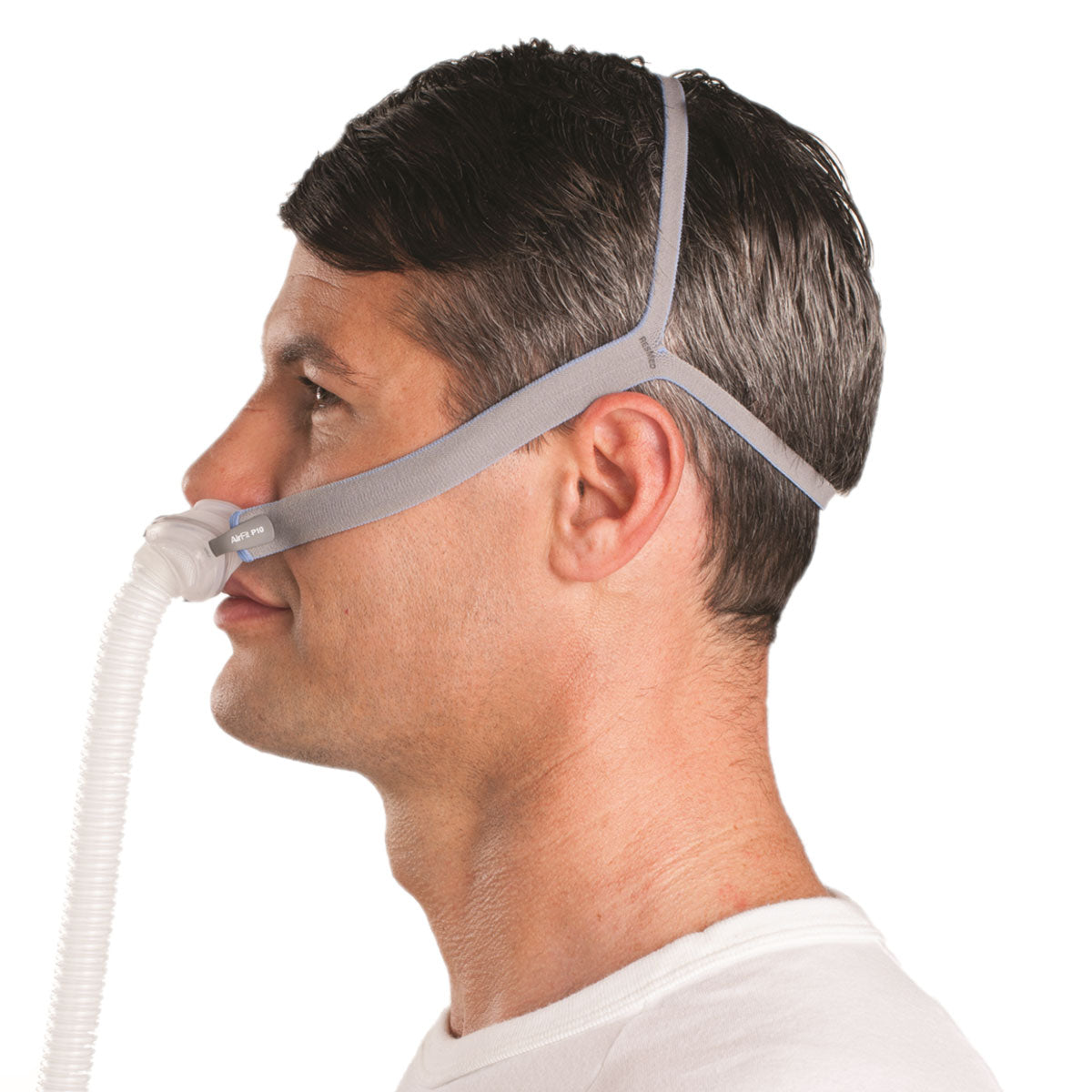 Man facing left wearing ResMed AirFit P10 nasal pillow CPAP mask with headgear