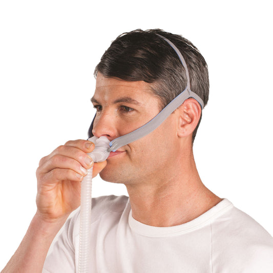 Man wearing ResMed AirFit P10 nasal pillow CPAP mask with headgear