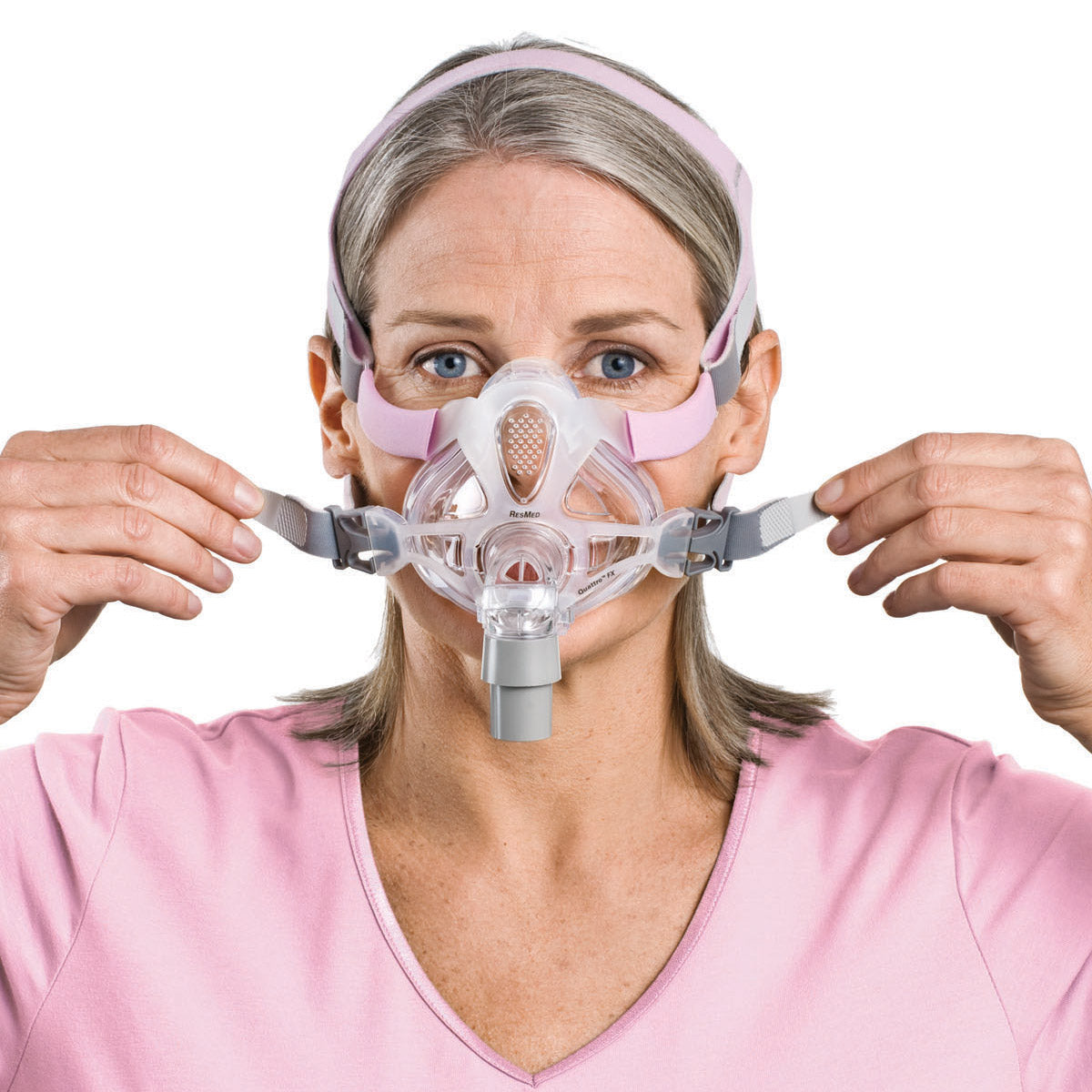 Stock photo of a woman wearing ResMed Quattro FX for her full face CPAP mask with headgear