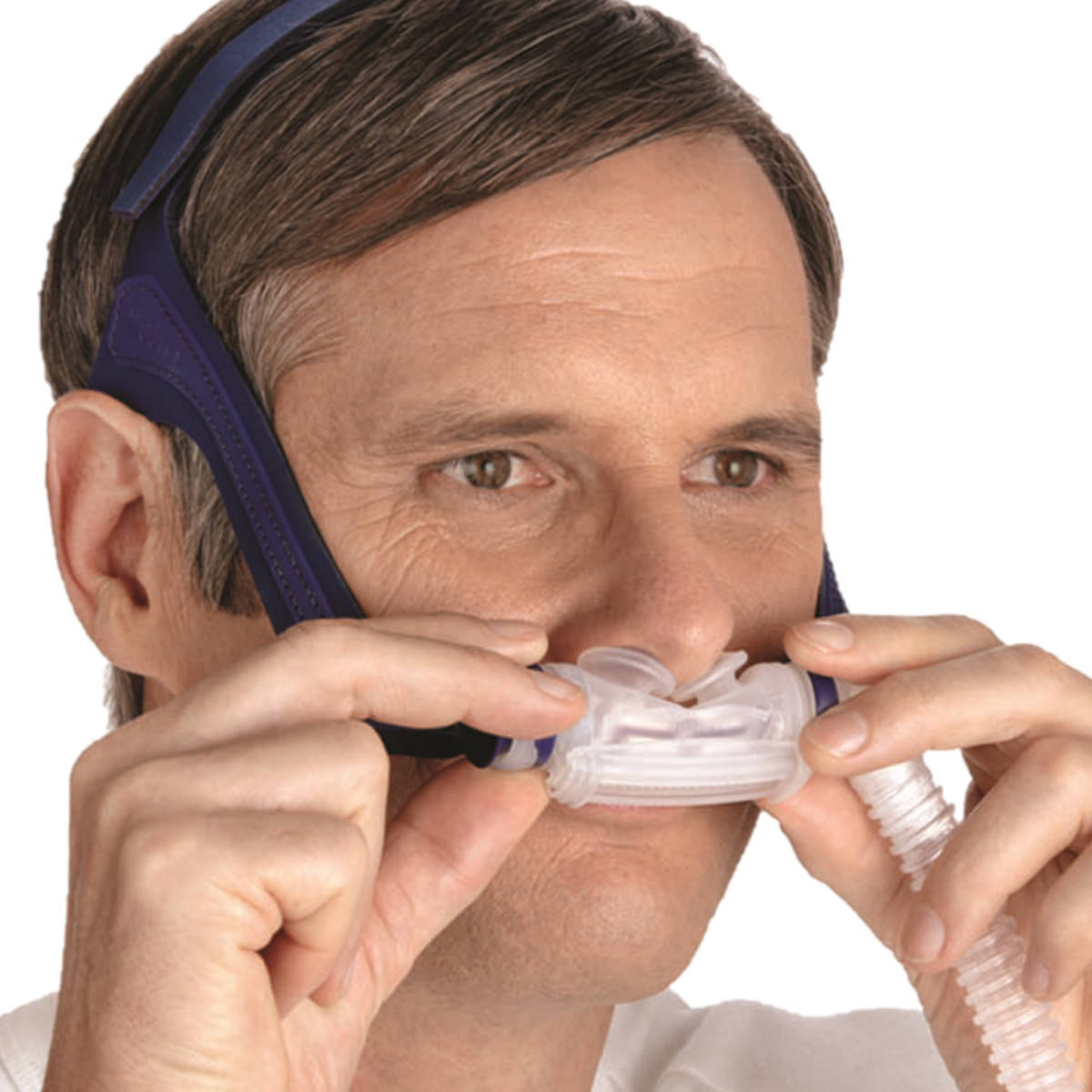 Stock photo of man wearing ResMed Mirage Swift II nasal pillow CPAP mask with headgear