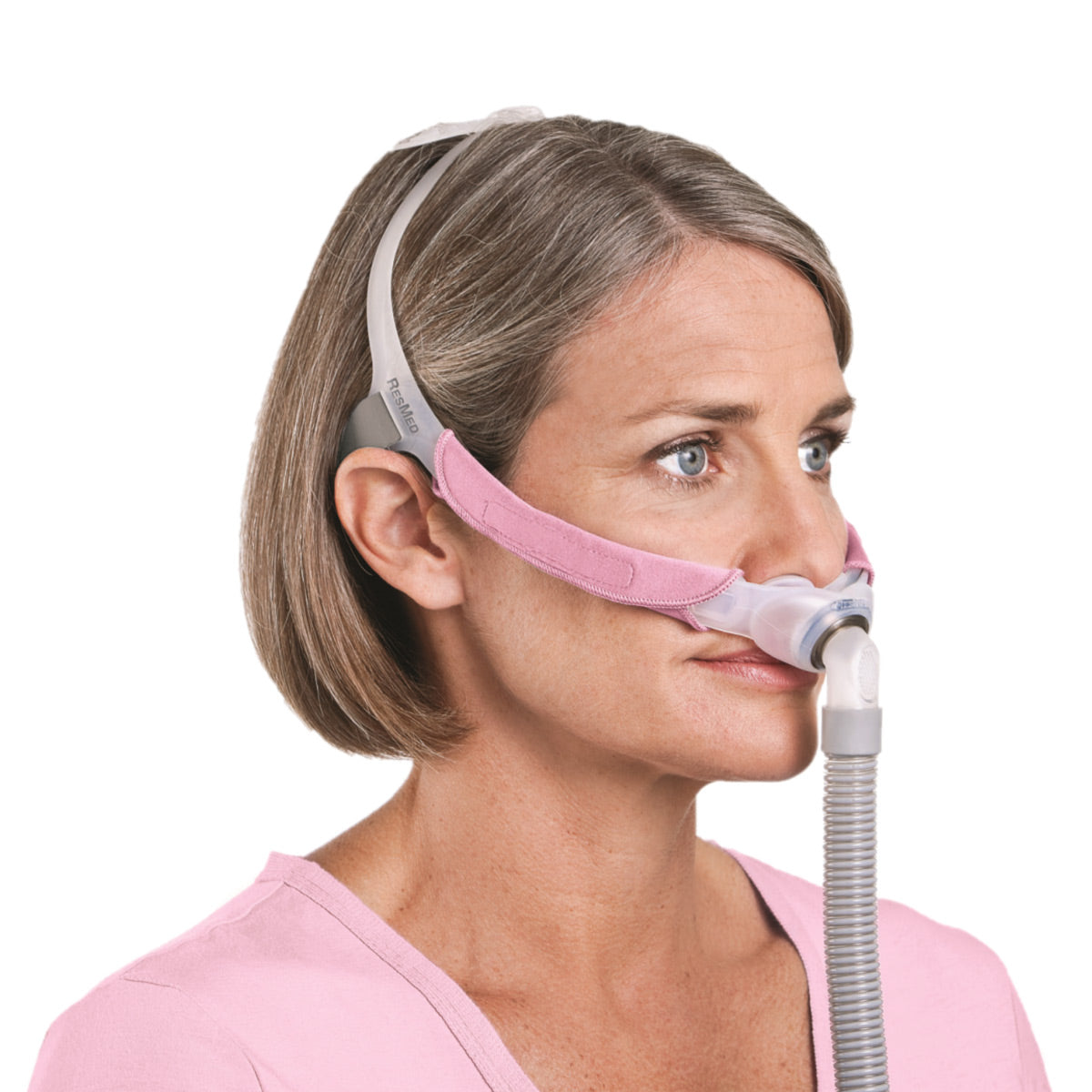 Stock photo of woman wearing ResMed Swift FX for her nasal pillow CPAP mask with headgear