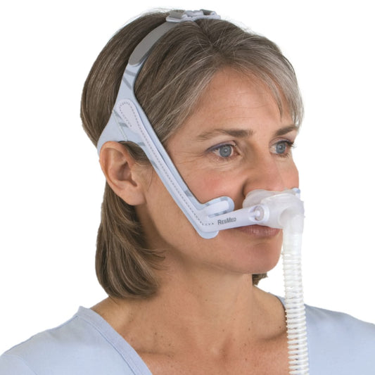 Stock photo of Woman wearing ResMed Swift LT for her nasal pillow CPAP mask and headgear
