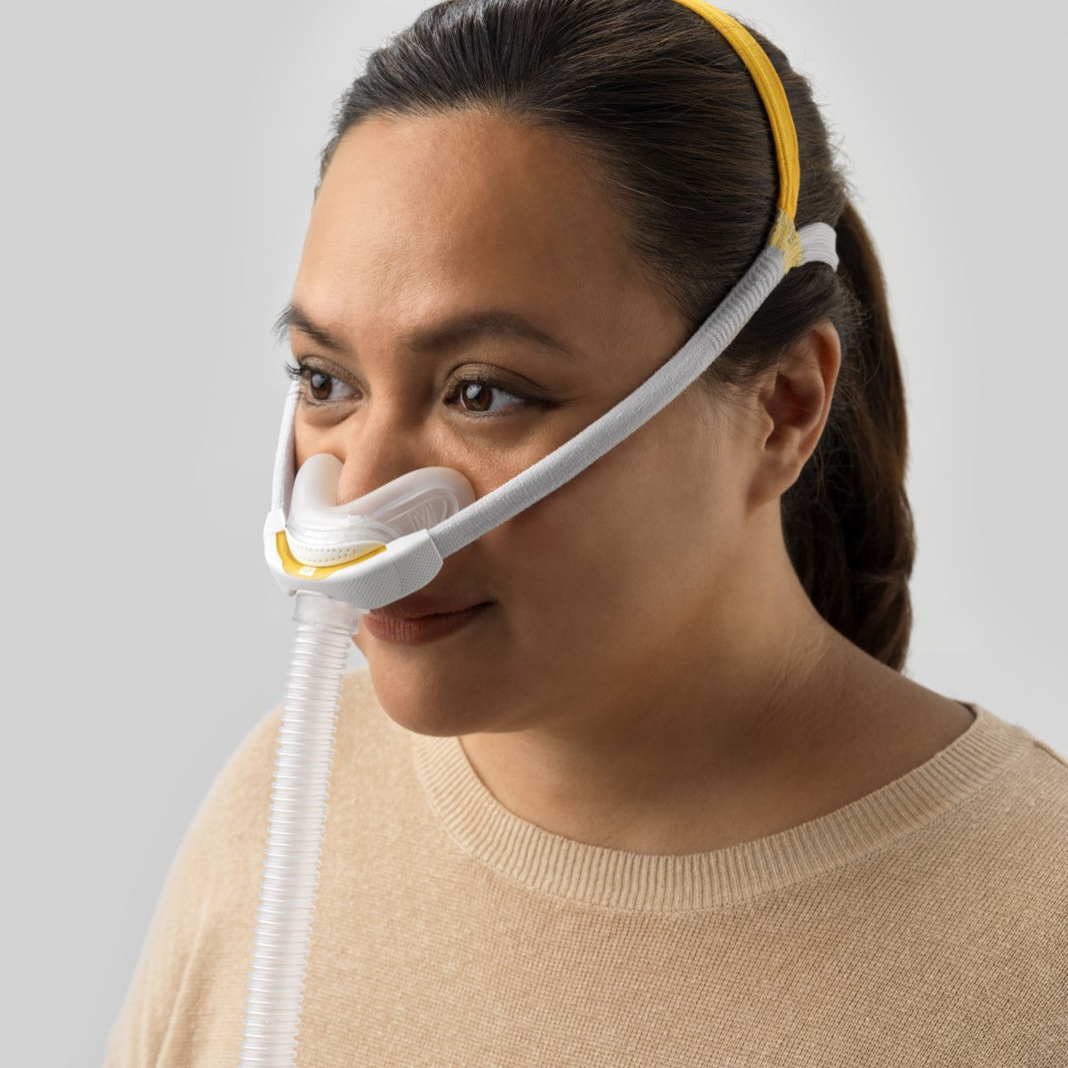 Stock Image of Woman Wearing Fisher & Paykel's Solo Nasal CPAP Mask W/ Headgear