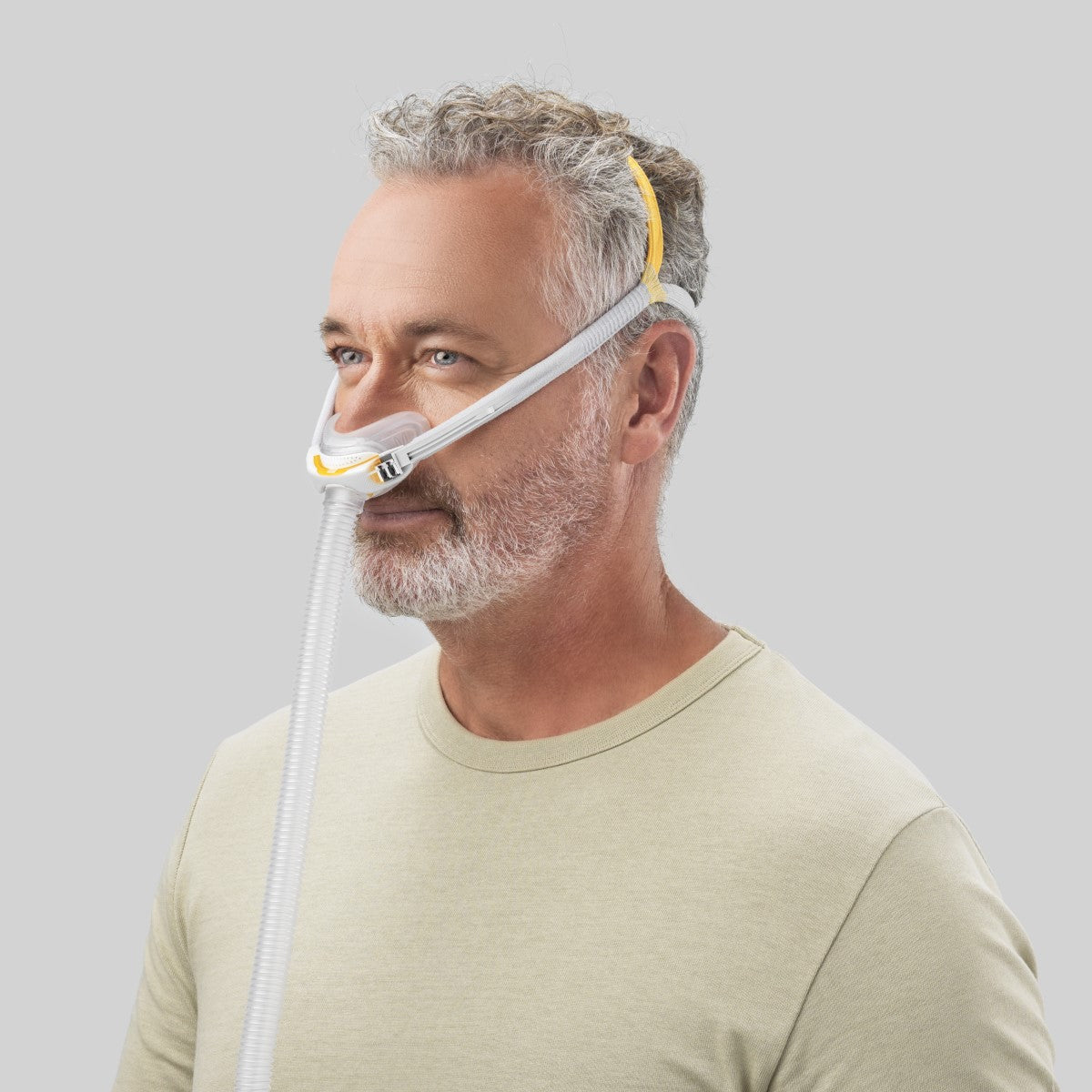Angled View of Man Wearing Fisher & Paykel's Solo Nasal CPAP Mask W/ Headgear