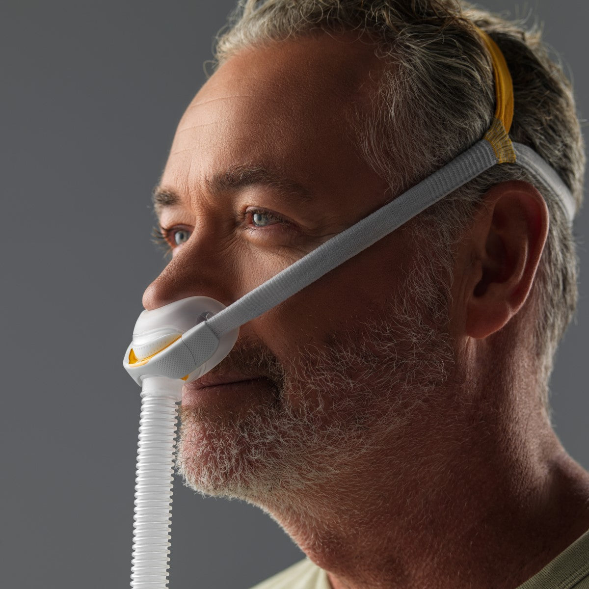 Angled View of Man Wearing Fisher & Paykel's Solo Nasal CPAP Mask W/ Headgear
