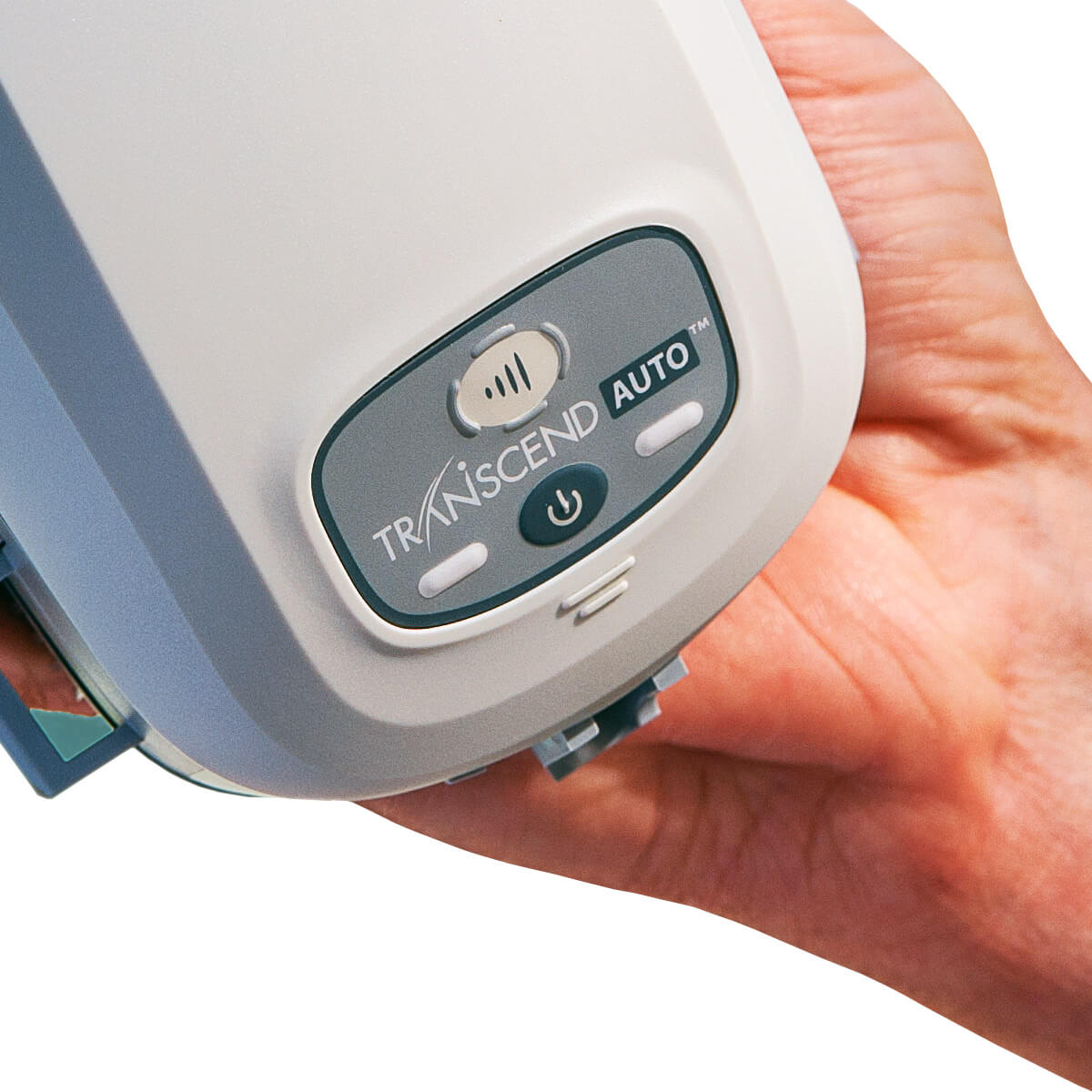 Hand holding a Somnetics Transcend Mini Auto CPAP With EZEX CPAP machine