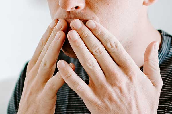 Stock Image of Man Firmly Placing on Somnifix Mouth Strips