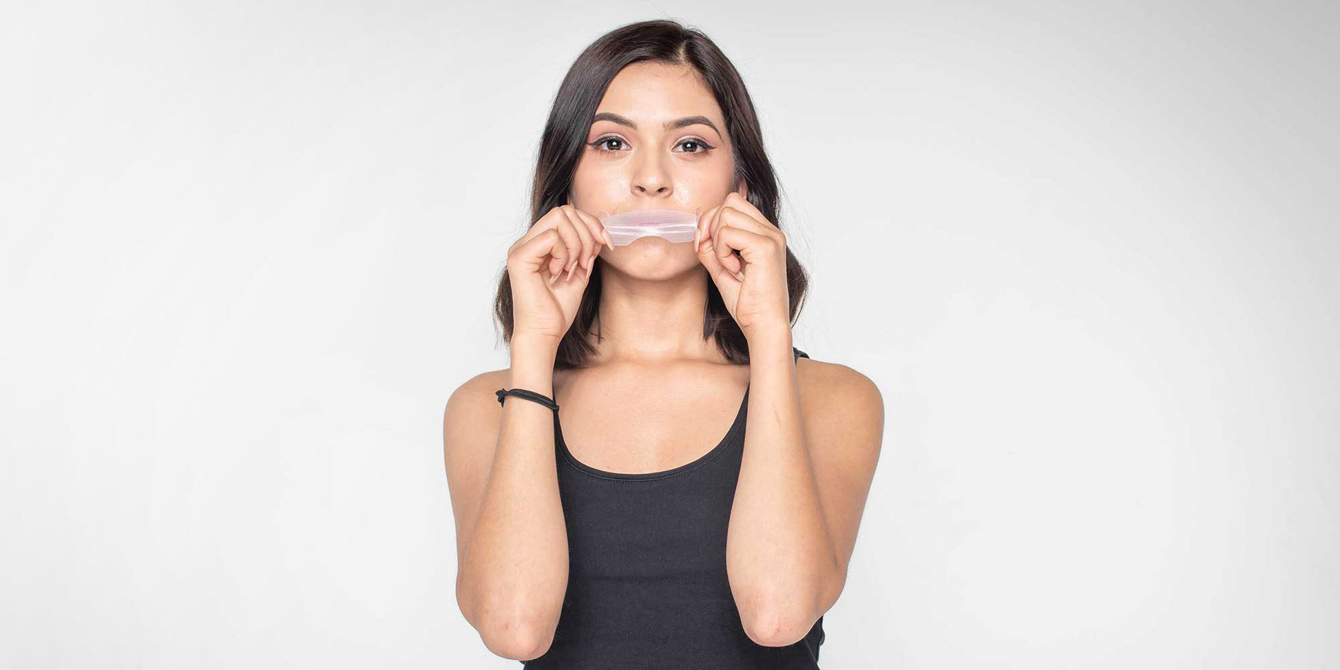 Stock Image of Woman Trying on Somnifix Mouth Strips