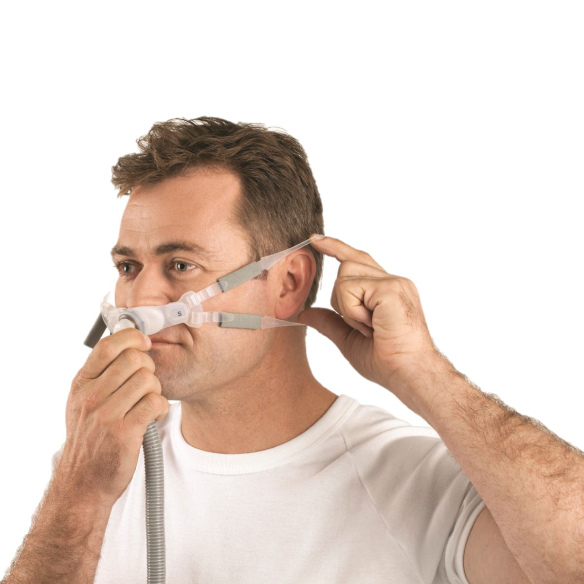 Stock Image of Man Fitting His ResMed Swift FX Bella Gray Nasal Pillow CPAP Mask W/ Headgear