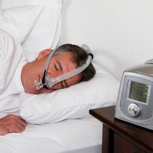 Person Sleeping on Their Side Using Tap Pap Nasal Pillow CPAP Mask W/ Headgear & Stability Mouthpiece
