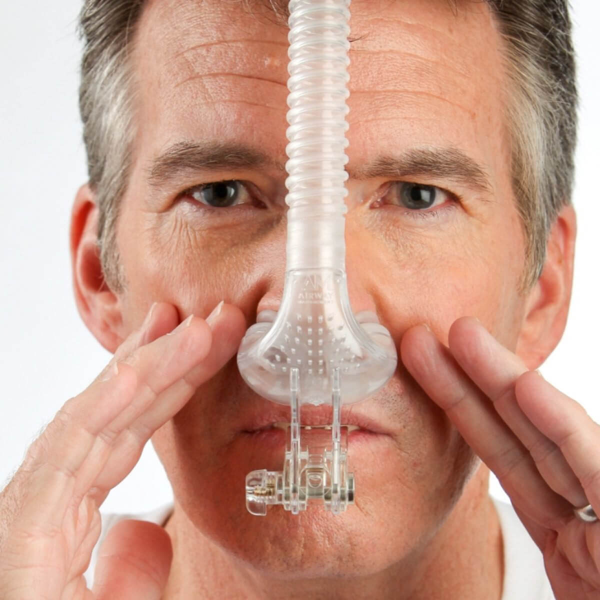 Person Fitting Their Tap Pap Nasal Pillow CPAP Mask W/ Stability Mouthpiece