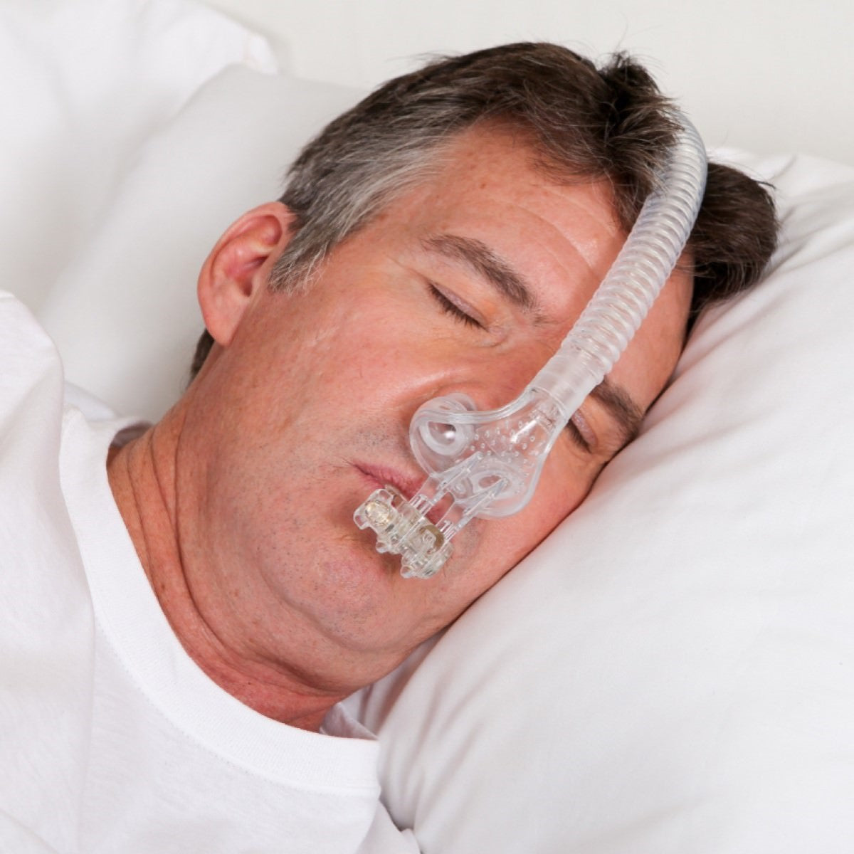 Person Sleeping Using Tap Pap Nasal Pillow Mask W/ Stability Mouthpiece