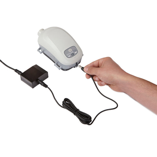 Stock photo of had plugging Transcend CPAP mobile power adapter into Transcend Auto machine