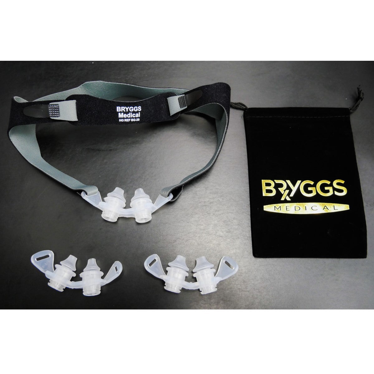 Photo of Bryggs Medical ULTepap headgear strap attached to a cushion with two other cushions and bag in the picture