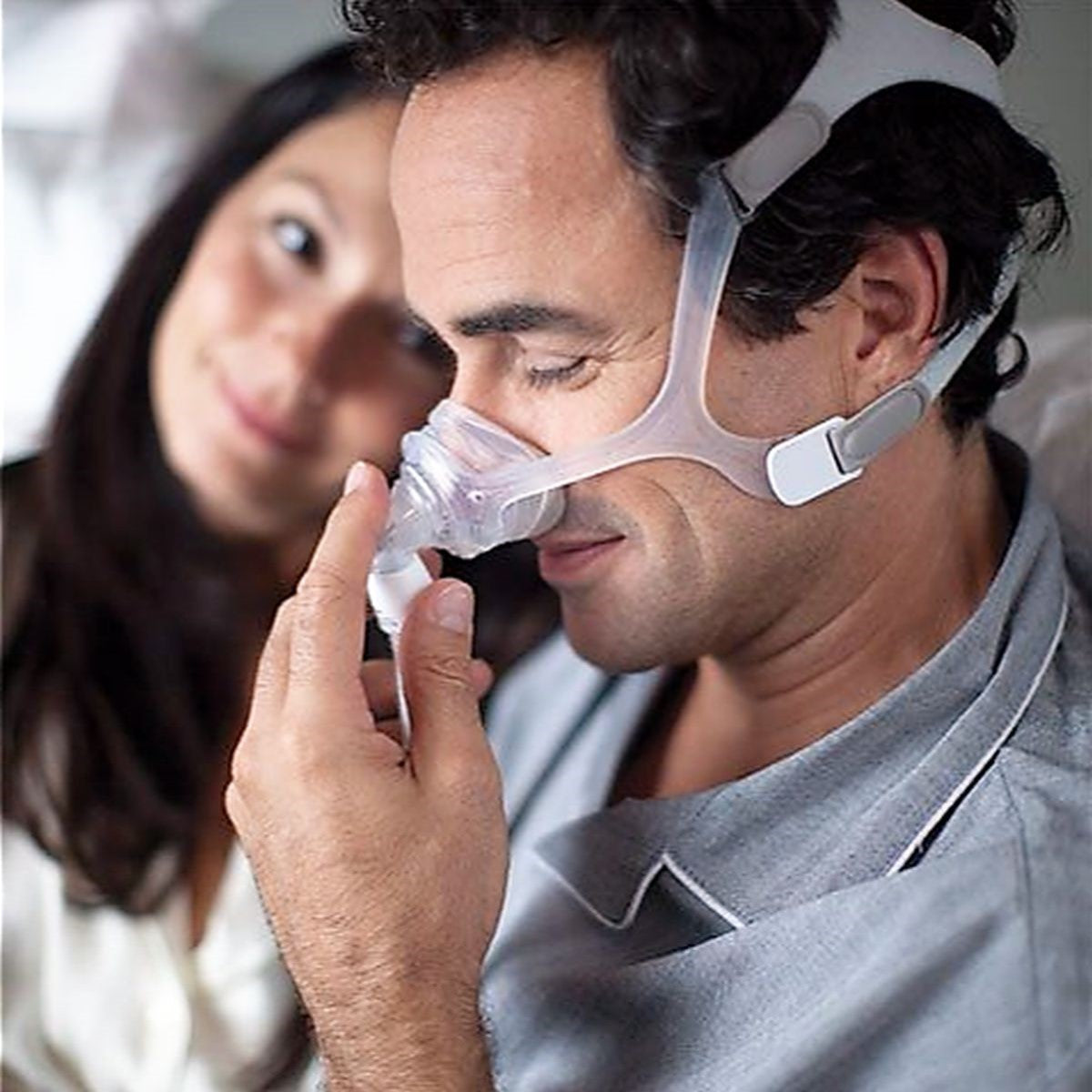 Man adjusting his Philips Respironics Wisp CPAP mask short tube assembly hose