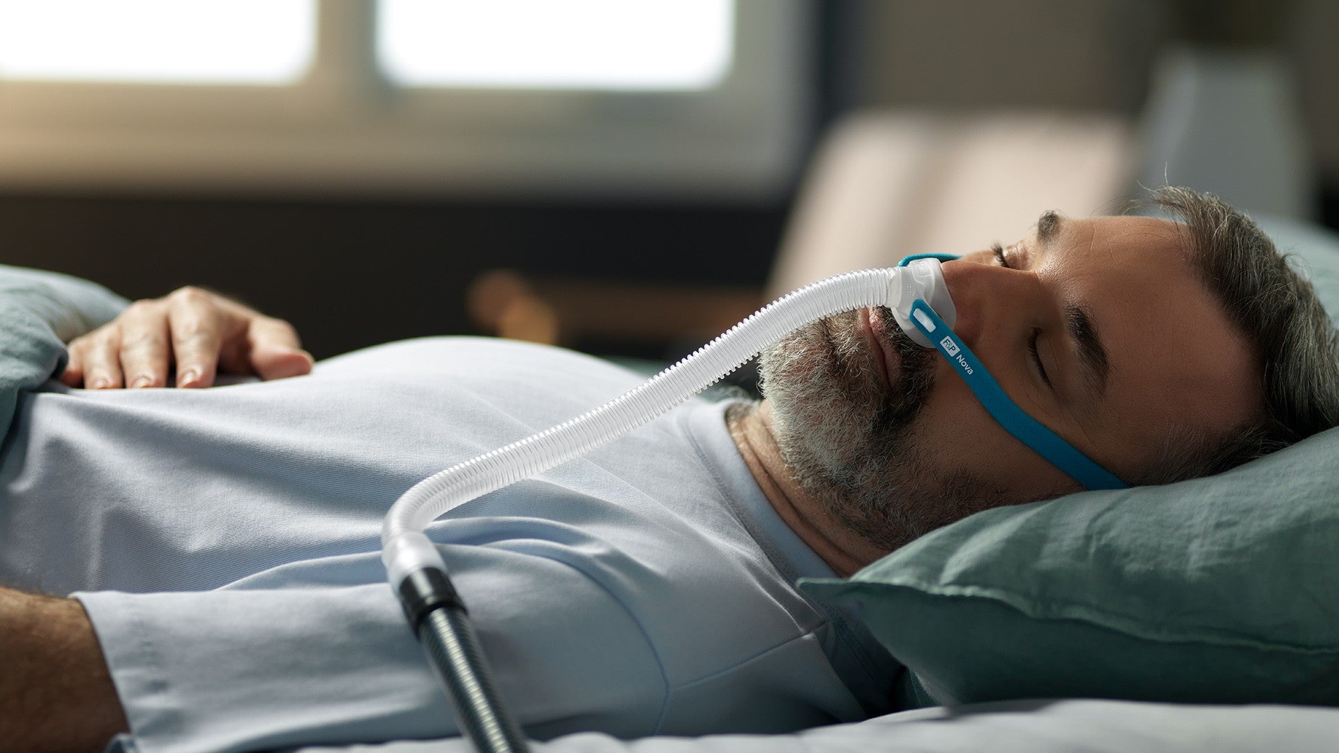 Man Sleeping with Fisher Paykel Micro Nova Mask