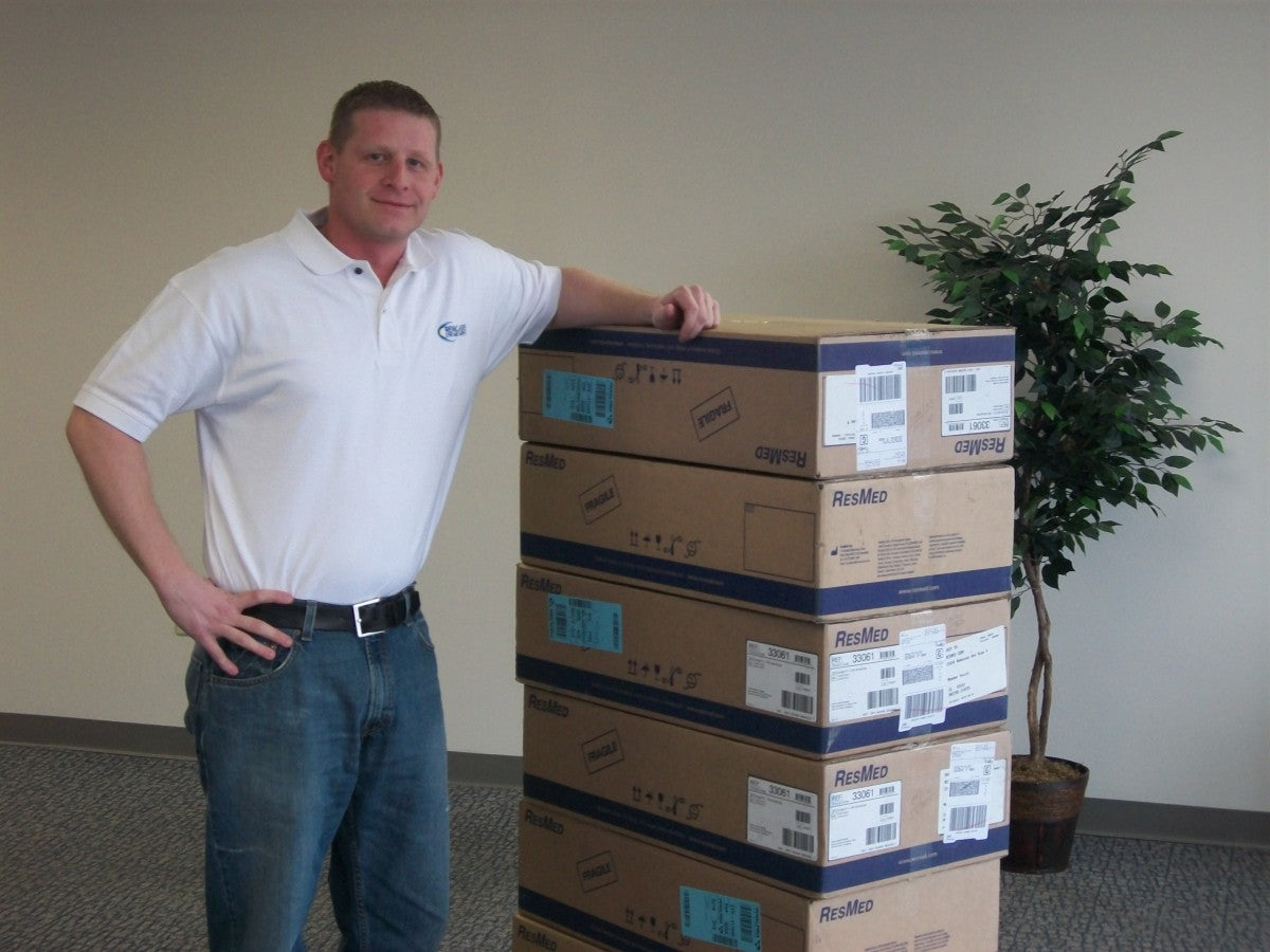 Photo of Co-Owner Jason Crowe with ResMed Boxes