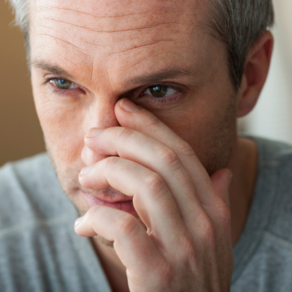 Man holding his septum wondering if it is deviated
