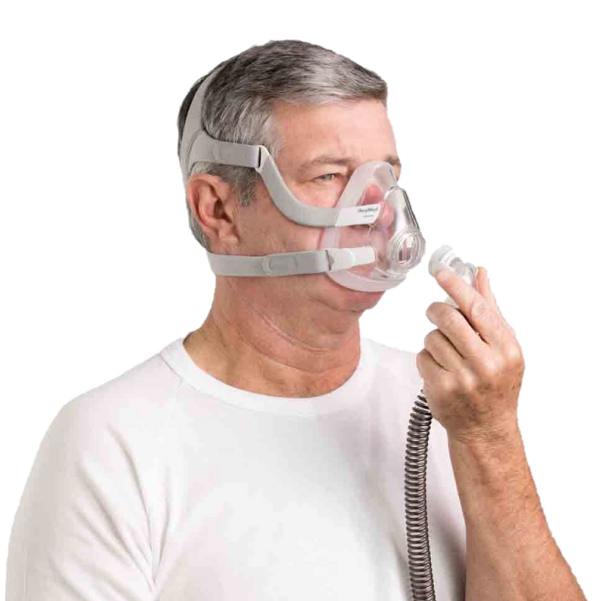 Stock Image of Man Connecting Her CPAP Hose Tubing to His Full Face CPAP Mask