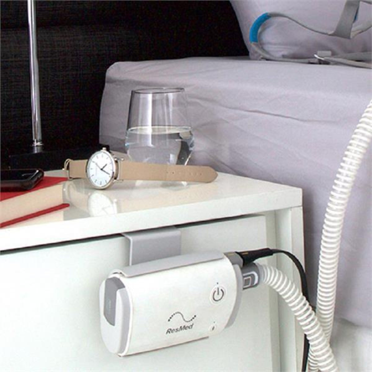 Photo of ResMed AirMini Bed Caddy Mounting System holding an AirMini